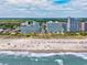 Aerial view of a beachfront resort with a wide sandy beach, ocean waves, and resort buildings at 5300 N Ocean Blvd. # 422, Myrtle Beach, SC 29572