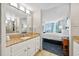 Clean bathroom with granite countertop vanity and access to the bedroom with balcony views at 5300 N Ocean Blvd. # 422, Myrtle Beach, SC 29572