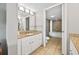 Bright bathroom with granite countertop vanity, white cabinets, and doorway to the shower and toilet at 5300 N Ocean Blvd. # 422, Myrtle Beach, SC 29572