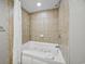 Luxurious bathtub with shower and tile surround in a bright and clean bathroom at 5300 N Ocean Blvd. # 422, Myrtle Beach, SC 29572