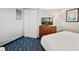 Cozy bedroom features a dresser with a TV, and vibrant blue patterned carpeting at 5300 N Ocean Blvd. # 422, Myrtle Beach, SC 29572