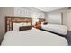 Comfortable bedroom featuring two twin beds, soft white linens, and stylish headboards at 5300 N Ocean Blvd. # 422, Myrtle Beach, SC 29572