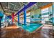 Inviting indoor pool with lifeguard sign, bright murals and natural light, perfect for relaxation and exercise at 5300 N Ocean Blvd. # 422, Myrtle Beach, SC 29572