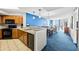 Open kitchen and living area featuring modern appliances, beautiful blue accent wall, and stunning ocean views at 5300 N Ocean Blvd. # 422, Myrtle Beach, SC 29572