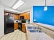 Bright kitchen with tile floor, stainless steel sink, and wood cabinets with granite countertops at 5300 N Ocean Blvd. # 422, Myrtle Beach, SC 29572