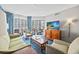 Relaxing living room with comfortable seating, a large TV, and a balcony overlooking the beach at 5300 N Ocean Blvd. # 422, Myrtle Beach, SC 29572