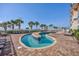 Outdoor pool with sprinklers, beach chairs, and clear blue sky, perfect for summer fun at 5300 N Ocean Blvd. # 422, Myrtle Beach, SC 29572