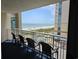 Beautiful balcony view of the ocean with chairs and a table for relaxing and entertaining at 5300 N Ocean Blvd. # 518, Myrtle Beach, SC 29577