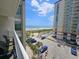 Scenic view of the beach, ocean, and pool from the condo balcony on a sunny day at 5300 N Ocean Blvd. # 518, Myrtle Beach, SC 29577