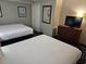 Comfortable bedroom featuring two beds, closet, and dresser with TV for a relaxing stay at 5300 N Ocean Blvd. # 518, Myrtle Beach, SC 29577