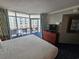 Bright bedroom with balcony overlooking ocean, complete with modern furnishings at 5300 N Ocean Blvd. # 518, Myrtle Beach, SC 29577