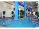 Indoor pool area with blue pillars, palm trees, and lounge seating at 5300 N Ocean Blvd. # 518, Myrtle Beach, SC 29577