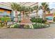 Beautifully landscaped resort entrance with a fountain, palm trees, and colorful flowers for a vibrant welcome at 5300 N Ocean Blvd. # 518, Myrtle Beach, SC 29577