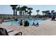 Gathering swimming pool with palm trees, lounge chairs, and beach views at 5300 N Ocean Blvd. # 518, Myrtle Beach, SC 29577