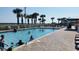 Gathering swimming pool with palm trees, lounge chairs, and beach views at 5300 N Ocean Blvd. # 518, Myrtle Beach, SC 29577