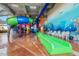 Colorful water slides at indoor water park with murals and seating at 5300 N Ocean Blvd. # 518, Myrtle Beach, SC 29577