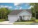 Inviting single-Gathering home with green siding, a two-car garage, stone accents, and a cozy front porch at 534 Magnolia Terrace Dr, Myrtle Beach, SC 29579