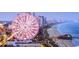 Oceanfront view with a Ferris wheel, offering entertainment and coastal scenery at 534 Magnolia Terrace Dr, Myrtle Beach, SC 29579