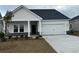Charming single-Gathering home featuring a two-car garage, landscaped yard, and inviting front porch at 534 Magnolia Terrace Dr, Myrtle Beach, SC 29579