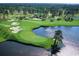 Aerial view of a pristine golf course with water features, showcasing the recreational amenities at 534 Magnolia Terrace Dr, Myrtle Beach, SC 29579