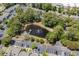 Aerial view of a tranquil neighborhood pond and well-maintained parking areas with lush green space and mature trees at 55 Shadow Moss Pl. # 55, North Myrtle Beach, SC 29582