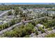 Aerial view of a townhome community with mature trees, a pool, and reserved parking, conveniently located near a pond at 55 Shadow Moss Pl. # 55, North Myrtle Beach, SC 29582