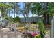 Landscaped backyard featuring decorative planters, lush greenery, and a well-maintained lawn, creating a peaceful outdoor retreat at 55 Shadow Moss Pl. # 55, North Myrtle Beach, SC 29582