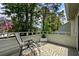 Cozy private balcony with a comfortable chair, a charming rug, and views of the surrounding nature, ideal for relaxation at 55 Shadow Moss Pl. # 55, North Myrtle Beach, SC 29582