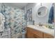 Nautical themed bathroom features a vanity, round mirror, and a playful turtle-themed shower curtain and toilet seat at 55 Shadow Moss Pl. # 55, North Myrtle Beach, SC 29582