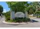 Elegant community entrance sign nestled among manicured landscaping, lush trees, and flowering plants welcoming residents and visitors at 55 Shadow Moss Pl. # 55, North Myrtle Beach, SC 29582