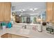 Open-concept kitchen with wooden cabinetry, white countertops, and a pass-through to the living room for easy interaction at 55 Shadow Moss Pl. # 55, North Myrtle Beach, SC 29582