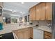Well-lit kitchen featuring wood cabinets and views of the adjacent living area promoting a seamless flow at 55 Shadow Moss Pl. # 55, North Myrtle Beach, SC 29582