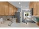 Bright kitchen featuring stainless steel appliances, light wood cabinets, and a view to the dining area at 55 Shadow Moss Pl. # 55, North Myrtle Beach, SC 29582