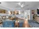 Bright living room with hardwood floors, neutral-toned sofa, and a view of the entryway and kitchen at 55 Shadow Moss Pl. # 55, North Myrtle Beach, SC 29582