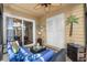 Relaxing covered patio with ceiling fan, comfortable seating, and sliding glass door access to the home's interior at 55 Shadow Moss Pl. # 55, North Myrtle Beach, SC 29582