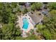 Aerial view of a refreshing community pool and relaxing lounge area surrounded by lush landscaping and mature trees at 55 Shadow Moss Pl. # 55, North Myrtle Beach, SC 29582