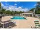 Community pool area featuring comfortable lounge chairs, shady umbrellas, and a cabana for relaxing by the pool at 55 Shadow Moss Pl. # 55, North Myrtle Beach, SC 29582