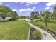 Expansive backyard features lush greenery, a serene pond, and a stone pathway at 552 Enoree Ct., Myrtle Beach, SC 29588