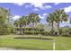 Charming single-story home with white brick, lush landscaping, palm trees, and inviting front porch at 552 Enoree Ct., Myrtle Beach, SC 29588