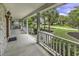 Inviting front porch with white railing offers serene views of the beautifully landscaped front yard at 552 Enoree Ct., Myrtle Beach, SC 29588