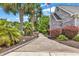 Paver walkway leads to the home, framed by lush plantings and featuring an American flag at 552 Enoree Ct., Myrtle Beach, SC 29588