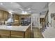 Kitchen features an island with cooktop, stainless appliances, wood cabinets, and wood floors at 552 Enoree Ct., Myrtle Beach, SC 29588