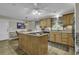 Spacious kitchen features an island with a built-in cooktop, wood cabinets and a dining area at 552 Enoree Ct., Myrtle Beach, SC 29588