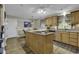 Kitchen features wood floors, cabinets, a center island with cook top and plenty of counter space at 552 Enoree Ct., Myrtle Beach, SC 29588