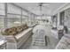 Bright sunroom features lots of natural light, comfortable seating, and ceiling fans at 552 Enoree Ct., Myrtle Beach, SC 29588