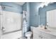 This bathroom has an all-white vanity, toilet, and shower/tub combo with blue accent paint at 5751 Oyster Catcher Dr. # 334, North Myrtle Beach, SC 29582
