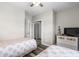 This bedroom features two twin beds, a dresser with a TV, and closet for storing clothes at 5751 Oyster Catcher Dr. # 334, North Myrtle Beach, SC 29582