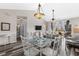 Bright dining area with glass table, pendant lighting, and easy access to living room, kitchen, and hallway at 5751 Oyster Catcher Dr. # 334, North Myrtle Beach, SC 29582