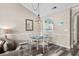 Inviting dining area featuring a glass-top table, chairs, modern light fixture, and a view into the kitchen at 5751 Oyster Catcher Dr. # 334, North Myrtle Beach, SC 29582