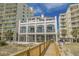 Elegant three-story beach house with multiple balconies, showcasing stunning architectural design and ocean views at 5751 Oyster Catcher Dr. # 334, North Myrtle Beach, SC 29582